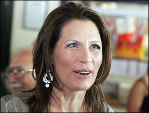 Republican presidential candidate Michele Bachmann speaks with a supporter during a breakfast chat earlier this week