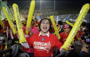 South Koreans rally Wednesday in support for Pyeongchang's bid to host the 2018 Winter Games in front of a ski jumping hill in Pyeongchang, South Korea.