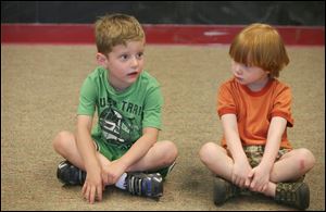 Cameron Manthey, left, and Preston Worth, both 4, listen attentively to a guest speaker during a Safe-T-City  session held in the classroom at Crossroads Community Church in Ottawa Lake, Mich. 