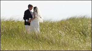 Former U.S. Rep. Patrick Kennedy (D., R.I.), the son of the late U.S. Sen. Edward Kennedy, walks through the beach grass with his wife, Amy Petitgout, after their wedding ceremony at the Kennedy Compound in Hyannisport, Mass.