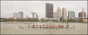 Boats race during the Great Maumee River Dragon Boat Festival near International Park in Toledo last year.