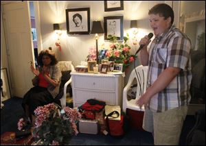 Jean Holden claps along as Drake Schlagheck, 13, sings in her home during a lesson. The songstress has been guiding the up-and-coming teen performer since he was 7.