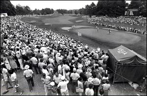 Fans line the 18th fairway and green as Arnold Palmer lines up a putt at the 1979 U.S. Open at Inverness Club.