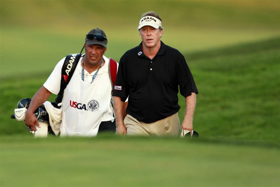 Michael-Allen-walks-up-the-18th-fairway