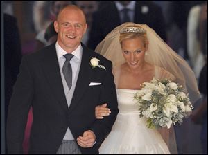 Britain's Zara Phillips, the eldest granddaughter of Queen Elizabeth, and her husband, England rugby player Mike Tindall, leave Canongate Kirk in Edinburgh after their marriage Saturday.