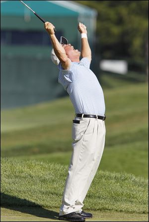 Olin Browne thrusts his arms into the air after sinking his birdie putt on the 18th hole, securing the
U.S. Senior Open championship. Browne sat atop the leaderboard the entire week at Inverness Club.