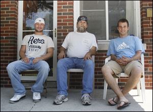 ADAMS House founder Dan Hill, center, joins two of the drug and alcohol addiction support program's charges, Johnny B., left, and Joe D. The program doesn't divulge the last names of its participants.