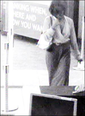 This woman was photographed by a surveillance camera as she robbed the Charter One Bank on Detroit Avenue in May.