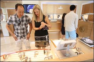 Insoo Hyun, left, and his wife, Leneigh Hyun, of Cleveland, Ohio, visit the Omega boutique at The Westin in Chicago, Illinois, on Saturday, July 16, 2011.