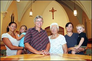 Andrea Coble and daughter Graci, Sister Shirley Shafranek and her mother, Beaty Dvorak, and Terry Smith and son Isaac prepare for today’s ceremony. Graci and Isaac will be gift bearers. Ms. Coble and Ms. Smith are two of Sister Shafranek’s daughters.