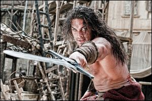 Jason Momoa portrays Conan in a scene from 'Conan the Barbarian.'