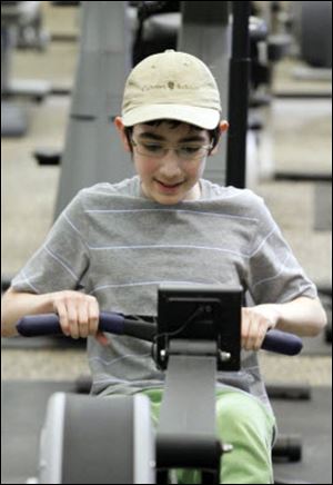 Isaac Ruben works out on the rowing machine.