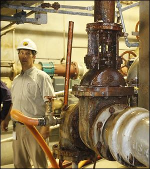 Andy McClure, staff engineer and acting administrator of maintenance at the Toledo Water Treatment Plant in East Toledo, watches as water leaks from an actuator on a 1940's era valve at the plant, Thursday, August 18, 2011.  