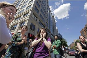 Office workers gather on the sidewalk in downtown Washington on Tuesday moments after a 5.9 magnitude tremor shook the nation's capitol. 