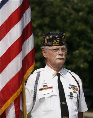 Douglas Hinkle marches with the American flag in the Veterans Appreciation Day parade in Northwood.