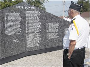 Bill Lyzan observes a memorial honoring Ohio's prisoners of war and soldiers who were missing. The memorial was set up as part of the Northwood Veterans Appreciation Day at the VFW Post No. 2984 Saturday. The event, which has been held more than 10 years, included barbeque dinner, a parade, and live music.