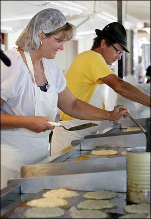 Linda Zunk and Kevin Ruedy keep potato pancakes coming. Festival-goers also indulged in lebkuchenherz — gingerbread hearts — schnitzel sandwiches, and more.