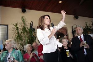 Republican presidential candidate Michele Bachmann talks to a group of supporters on the porch of Calistoga Bakery Cafe in Naples, Fla., on Monday, Aug. 29, 2011, during a campaign stop.