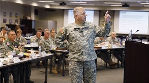 This April 18, 2011 photo shows Col. Bill Zieber, center, of the Ohio National Guard as he instructs a Joint Task Force Commander training class at NORAD/Northcom headquarters at Peterson Air Force Base, Colo. In classes like this the Defense Department is grooming a new type of commander to coordinate the military response to domestic disasters, hoping to save lives by avoiding some of the chaos that plagued the Hurricane Katrina rescue effort.