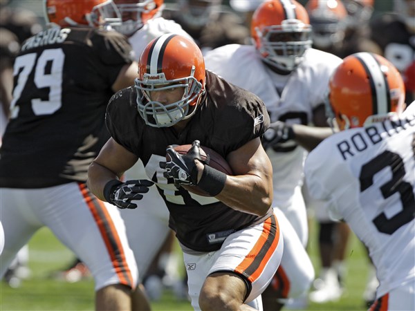 On the cover: Browns running back Peyton Hillis hands out Madden 12 video  game to teammates