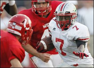 Central Catholic running back Cedric Gray (7) attempts to get by Bedford’s Thomas Ferry. Gray finished with 80 yards on 16 carries.