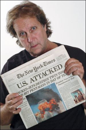 Former Toledoan Rocky Pinciotti, a photographer, displays the banner headline about the attacks.