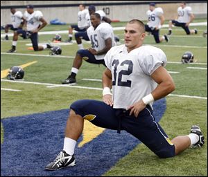 University of Toledo football player Danny Molls (32) warms up during practice in this 2010 file photo.