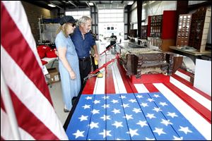 Janice Pennington of Fulton County and Earl Ogren of Lambertville look over a steel beam from the World Trade Center that was on display at the Fulton County Fair. The beam eventually will be part of a permanent memorial at the fairgrounds.