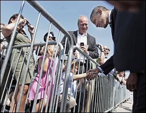 President Barack Obama, right, shakes hands with Trey Davis, 2, as he greets guest on the tarmac during his arrival at Rickenbacker International Airport in Columbus, Ohio, Tuesday, Sept., 13, 2011. (AP Photo/Pablo Martinez Monsivais)