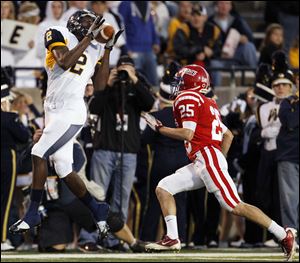 Whitmer wide receiver Nigel Hayes makes a catch Saturday night against St. Francis defender Angelo Spinazze.