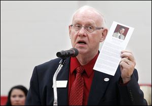 Dr. Larry McDougle, President, honors Owens Community College athletic director Mike Rickard, who died suddenly in late December during a ceremony on the court on February 16, 2011.