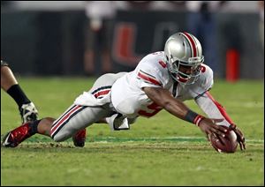 Ohio State quarterback Braxton Miller recovers his own fumble during the third quarter of an NCAA college football game against Miami, Saturday, Sept. 17, 2011, in Miami. Miami defeated Ohio State 24-6. 