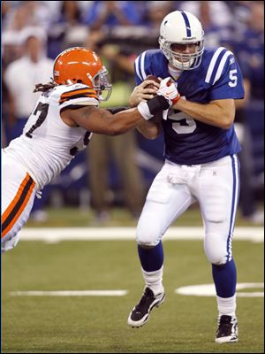 Cleveland defensive end Jabaal Sheard, left, begins to rip the ball away from Indianapolis quarterback Kerry Collins as the Browns held the Colts to 285 yards.