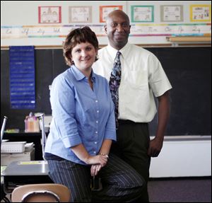 Jennifer Stoffel and Jewel Woodard pause in Karen Ash's classroom to remember their colleague. 'She wanted to … be around the kids,' Mr. Woodard says.