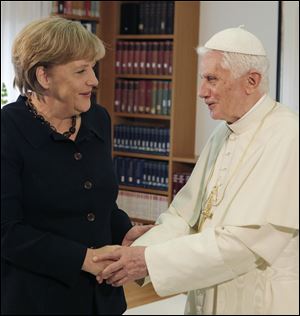 Pope Benedict XVI shakes hand with German Chancellor Angela Merkel, left, prior to a private meeting Thursday in the house of the German Bishops Conference in Berlin.