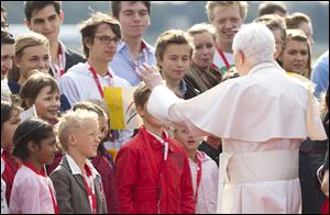 Pope Benedict XVI greets children Thursday after his arrival at Tegel airport in Berlin, Germany.