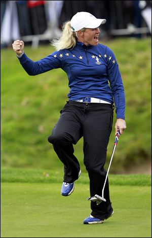 Europe’s Suzann Pettersen reacts on hole sixteen after holing a birdie putt while facing Michelle Wie. She added two more birdies to get the Europeans a crucial point.