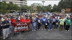 Postal workers during a rally dubbed as a Day of Action to Save America's Postal Service, Tuesday, Sept. 27, 2011, in Toledo, Ohio. The postal workers say they are trying to rally in every congressional district in the country with two aims: 1) to inform the public about the actual financial situation in the U.S. Postal Service and waht's at stake for residents and businesses throughout the country and 2) to explain how the the problems can be resolved, including by supporting House Bill 1351.