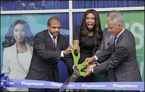 Chicago Alderman Will Burns, left, Grammy and Oscar-winning singer and actress Jennifer Hudson, Dave Burwick, President, Weight Watchers North America, and Chicago Mayor Rahm Emanuel take part in a ribbon cutting at the opening of 