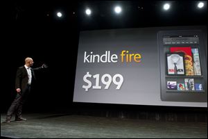 Amazon.com CEO Jeff Bezos unveils the new Kindle Fire tablet at a September 28, 2011 press event in New York City.