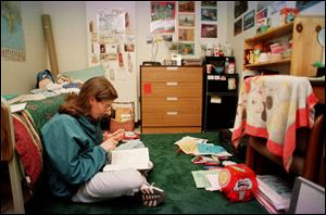 Ohio State University student Susu Behee, of Fremont, Ohio, studies in her dorm room in this 1999 file photo