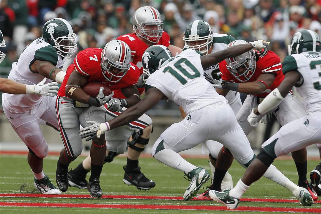 Ohio-State-tailback-Jordan-Hall-runs-into-MSU-defenders