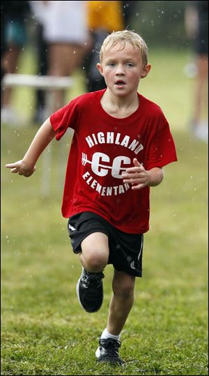 Drew Barnesky, 6, a kindergartner at Highland Elementary School, chugs toward his first-place finish on the half-mile course. His school's running club meets every Tuesday and Thursday.