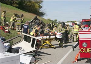 A passenger van towing a truck lost control on I-75 southbound in the area of the 202B Collingwood exit and overturned. 