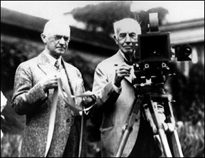 In this late 1020's file photo, Eastman Kodak Co. founder George Eastman, left, and Thomas Edison pose with their inventions in a photograph taken in the late 1920s.  Their contributions, Edison invented motion picture equipment and Kodak invented roll-film and the camera box, helped create the motion picture industry. Buffeted by fierce foreign competition, then blindsided by a digital revolution, photography icon Eastman Kodak Co. is teetering on a financial precipice after a quarter-century of failed efforts to find its focus.