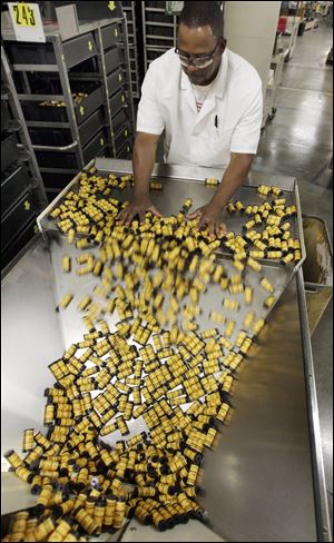 FILE - In this May 26, 2011 file photo, Kodak employee, Earl Blackmon, loads medium format film into a hopper for packaging during a product change in Rochester, N.Y.