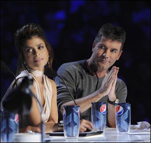 Judges Simon Cowell, right, and Paula Abdul are shown during auditions for the singing competition series 