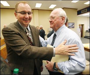 Robin Horvath, left, and Bob Bennett exchange pleasantries after Judge Gene Zmuda chose Bennett's TP Foods offer  for the Tony Packo's Inc. restaurant chain  Thursday.