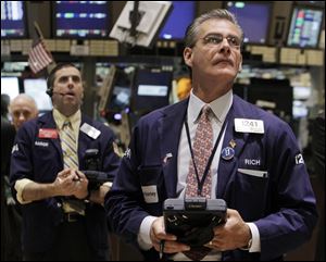 Traders Stephen Guilfoyle, left, and Richard Deviccaro, work on the floor of the New York Stock Exchange. 