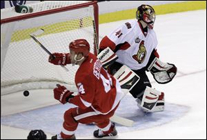 Todd Bertuzzi scores Detroit's first goal of the season as he slips the puck past Ottawa's Craig Anderson in the first period last night.